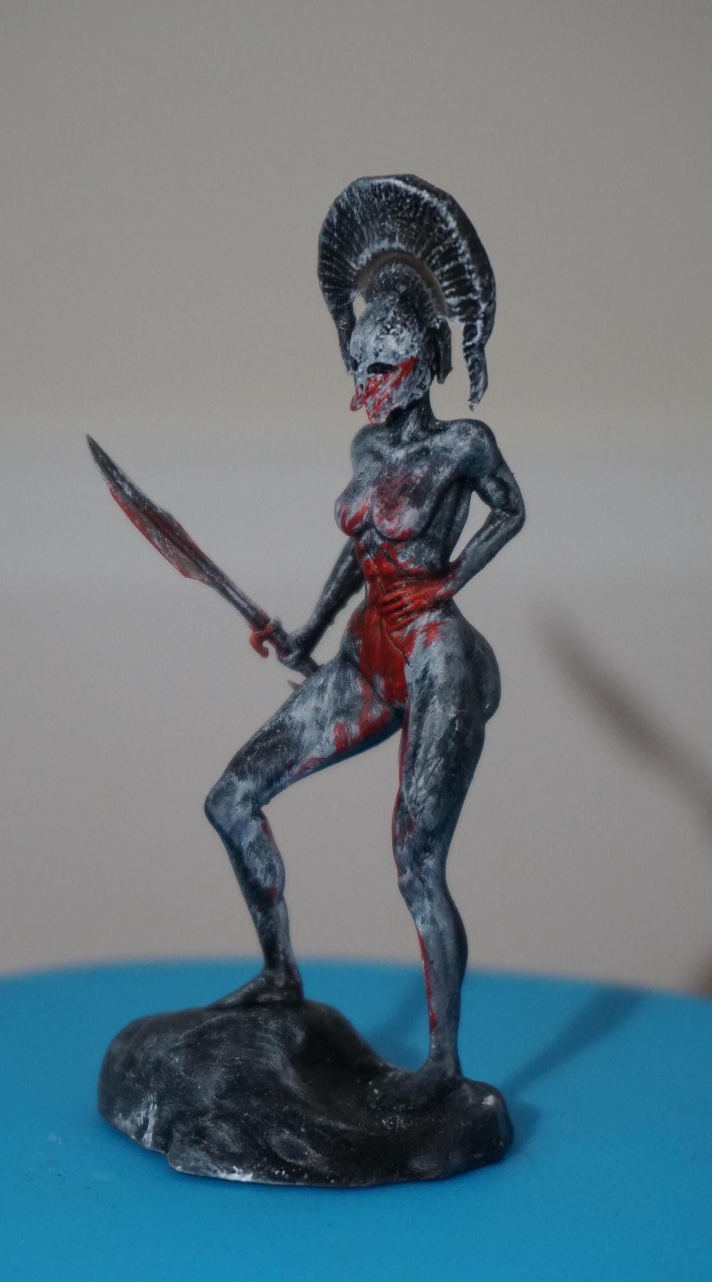 Endure – Wounded Hoplite Swordswoman Statue